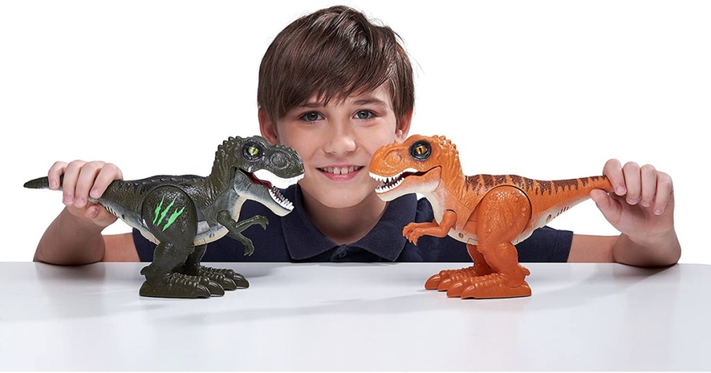 boy playing with two robo alive dinos