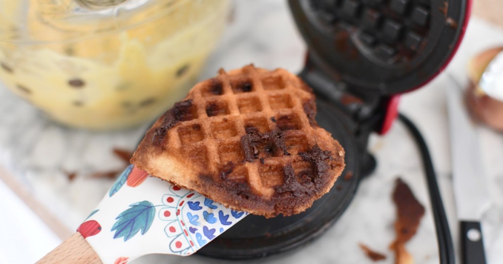 using a silicone spatula to remove waffle from waffle maker