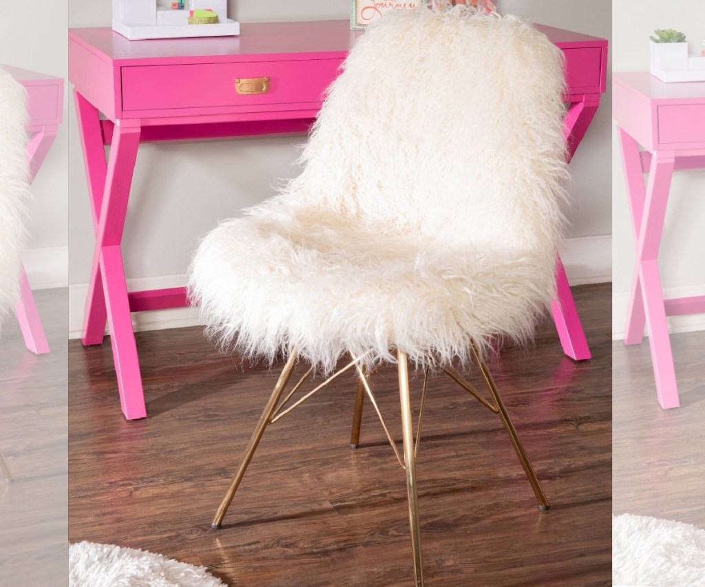 white faux fur chair near pink desk