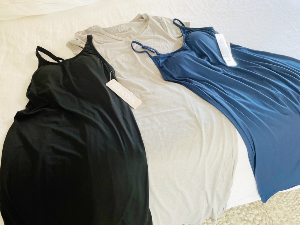 3 women's 32 degrees dresses laying on a bed
