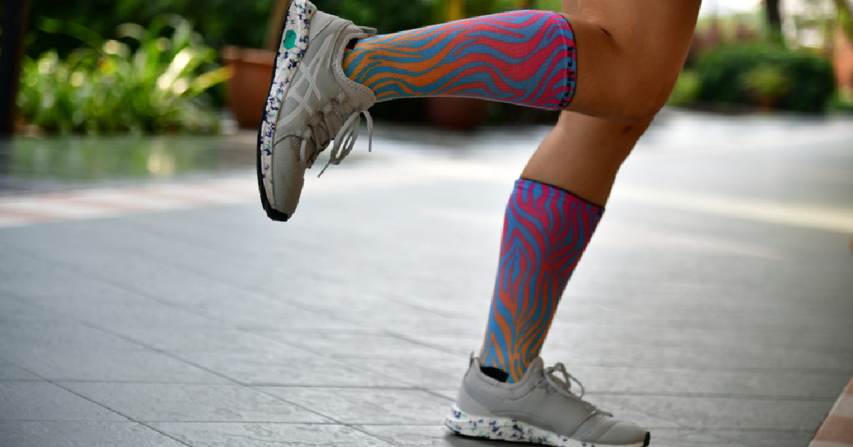 woman wearing grey pair of ASICS HyperGEL-SAI Running Shoes
