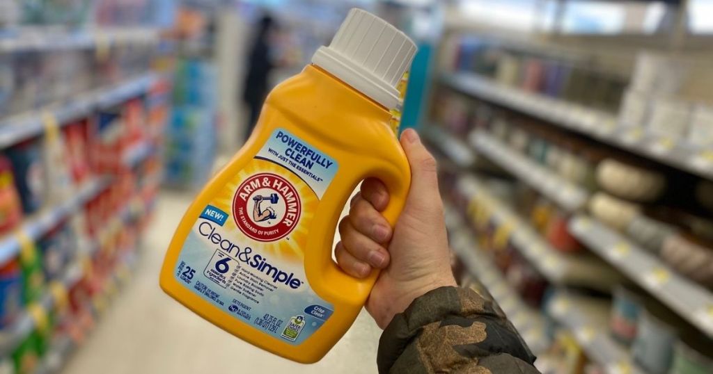 hand holding Arm & Hammer Laundry Detergent