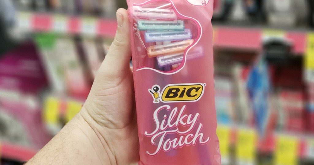 hand holding pack of women's disposable razors in store