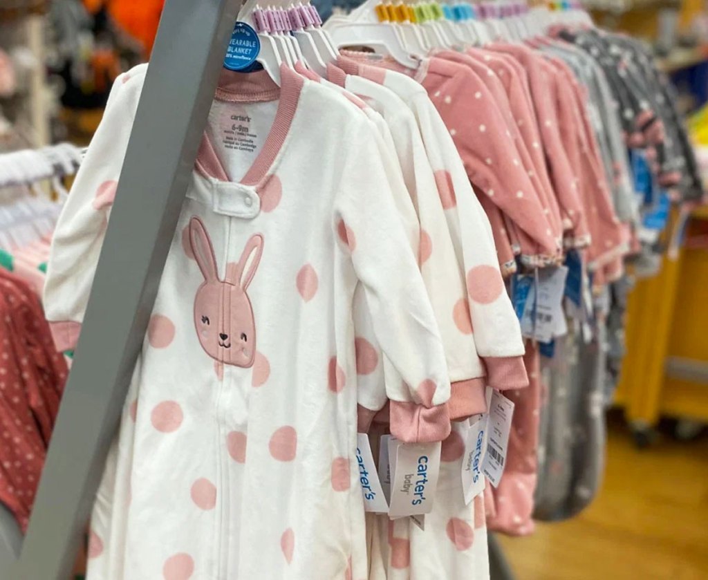 white and pink bunny print baby sleep bags on store display rack