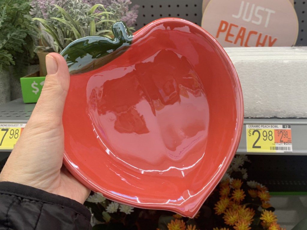Ceramic peach bowl in hand near in-store display