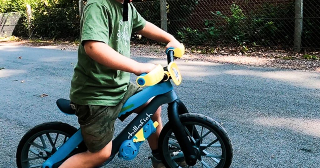 little boy sitting on a chillafish balance bike