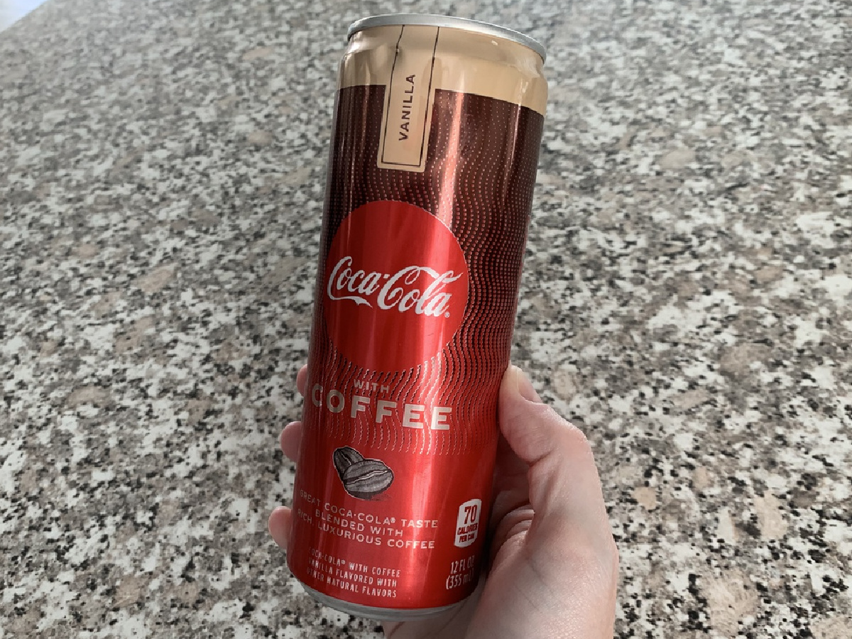 hand holding can of vanilla coffee flavored coca-cola