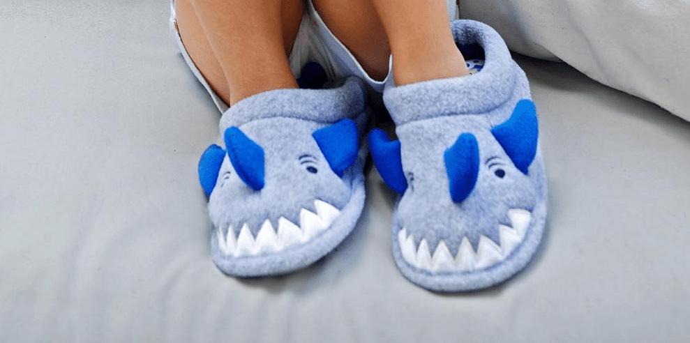 kid wearing shark slippers