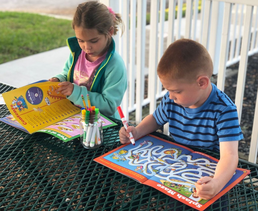 girl and boy coloring in highlights magazines