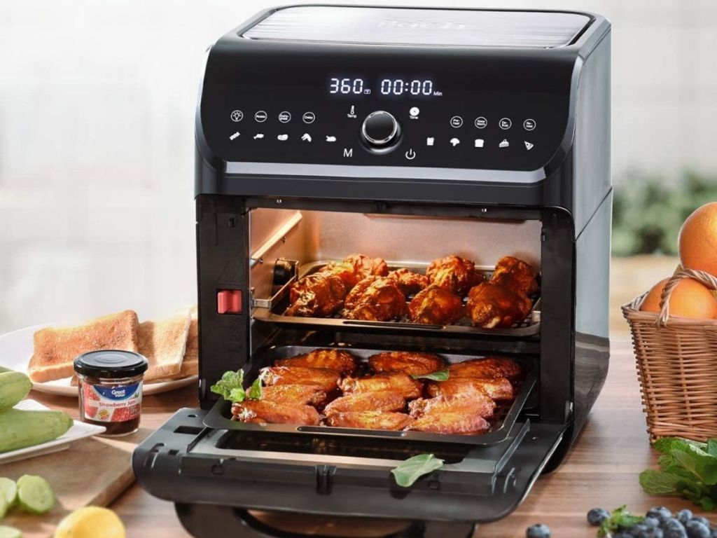  black air fryer oven with front opened showing chicken wings