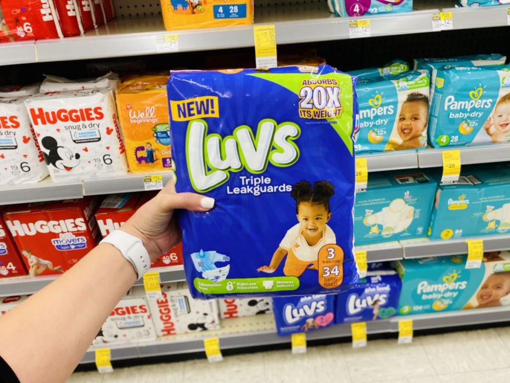 hand holding package of Luvs diapers