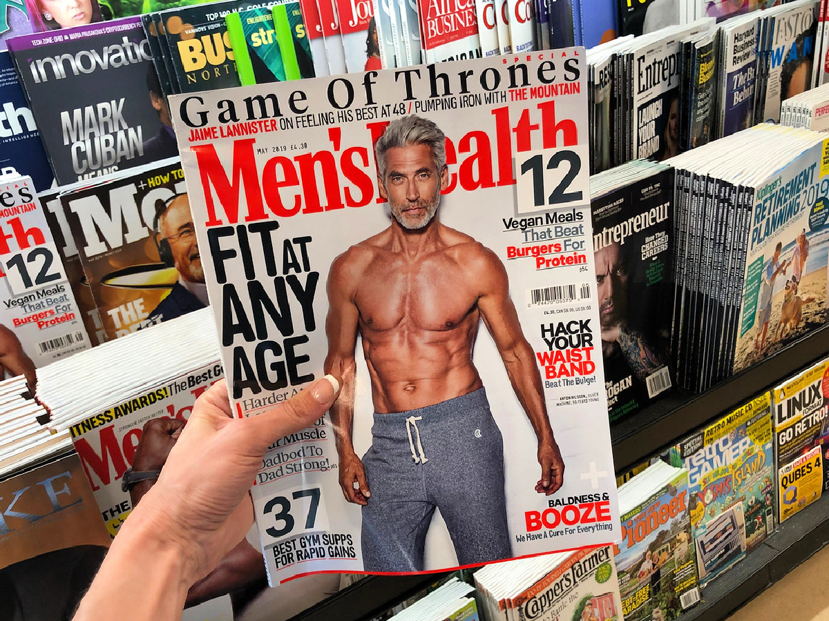 Men's Health magazine in hand