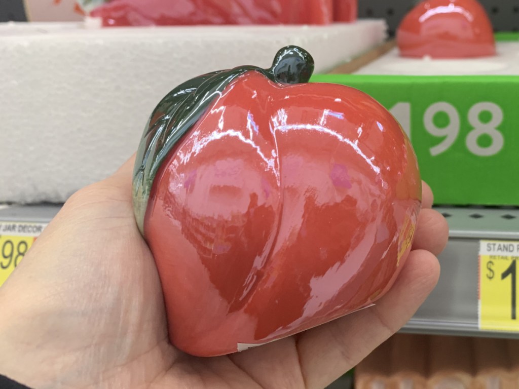 Metalic Crooked Peach Decoration in hand near in-store display