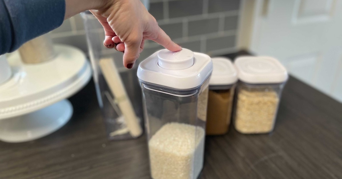 finger pushing top of OXO pop container