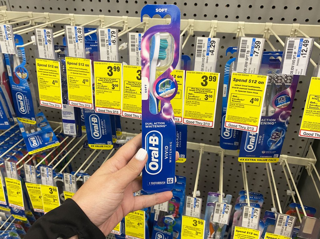 hand holding oral-b toothbrush in cvs