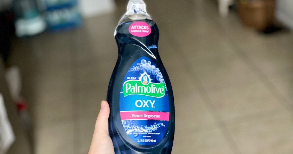 hand holding bottle of Palmolive Dish Soap w_ Oxy
