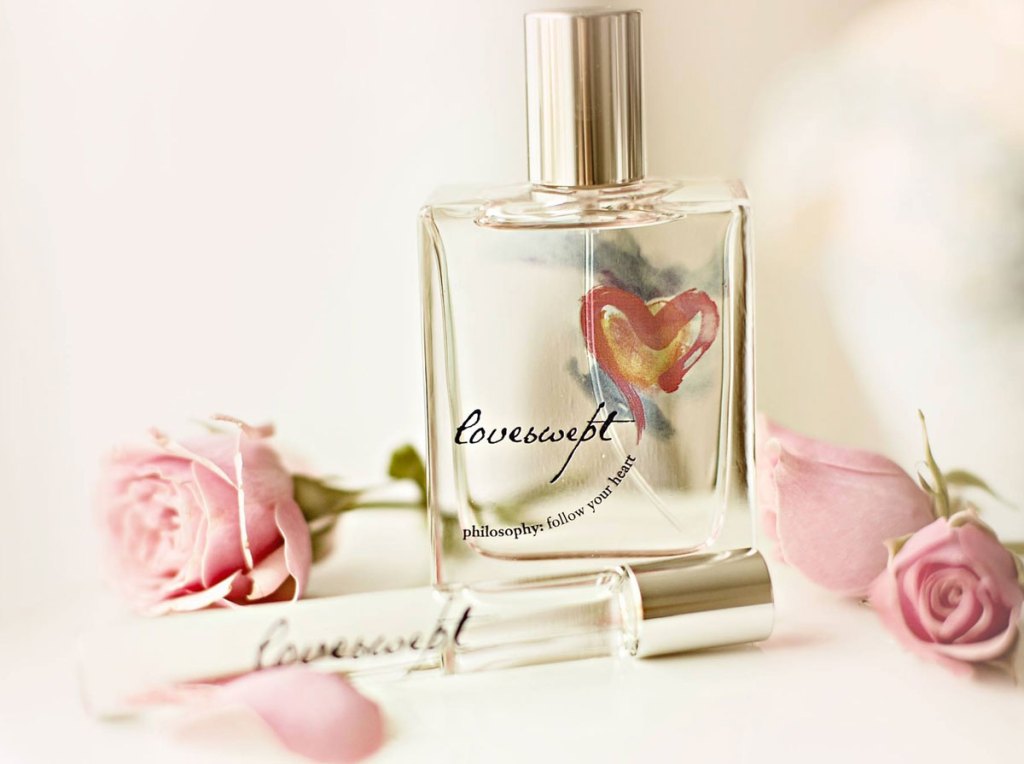 loveswept perfume with pink roses around it