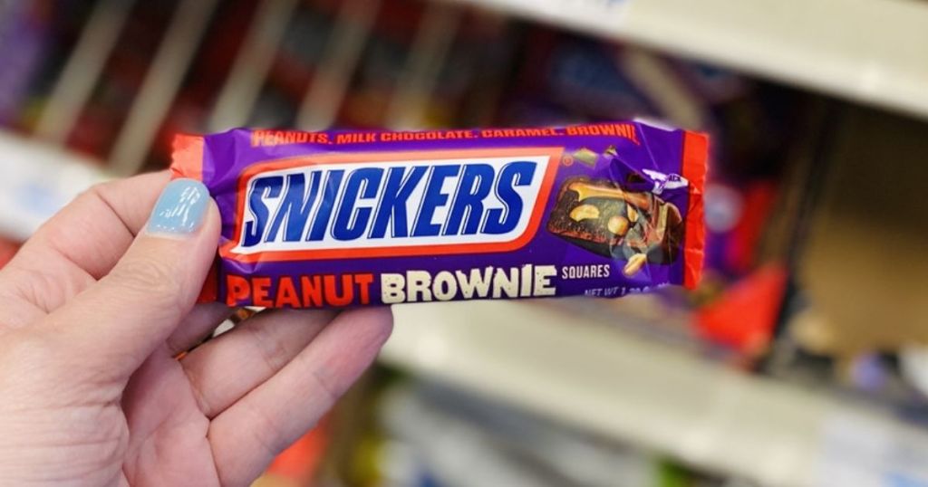 hand holding Snickers Peanut Brownie Squares