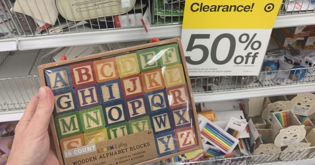 hand holding Target Wooden Alphabet Blocks in clearance section