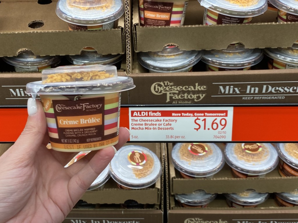 hand holding creme brulee cheesecake factory dessert at aldi 