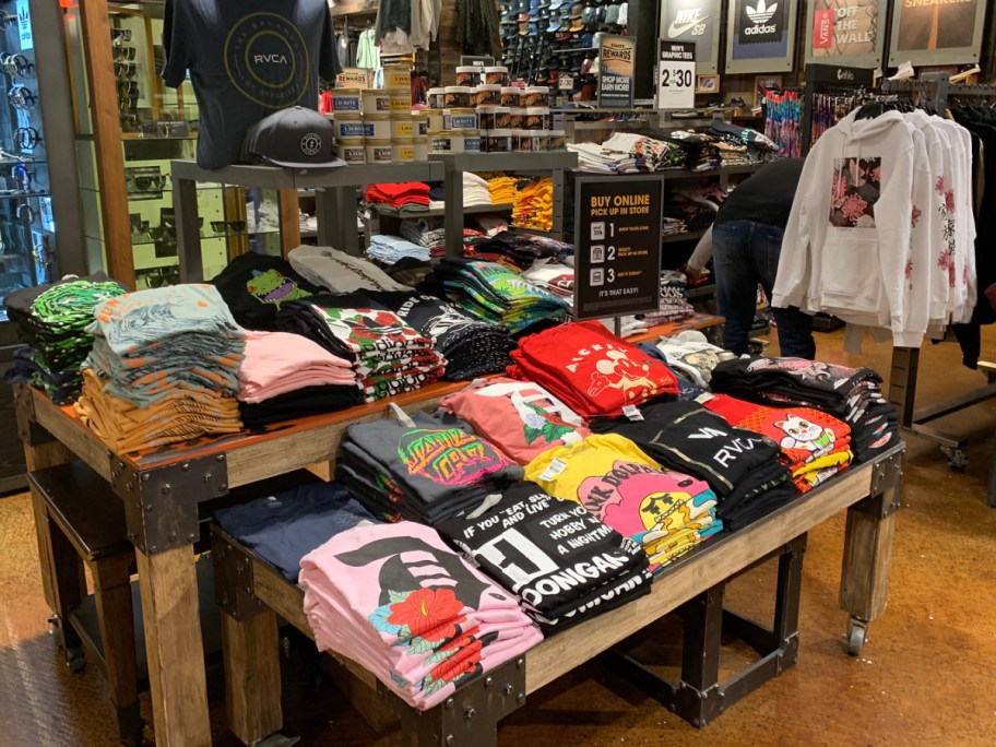 men's graphic tees display in store at tillys