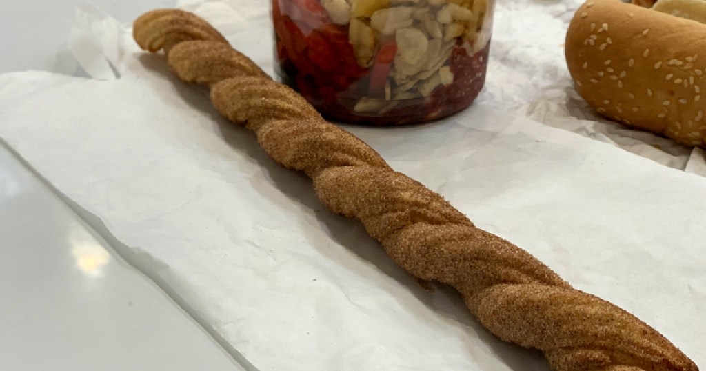a costco churro on a paper towel on a table