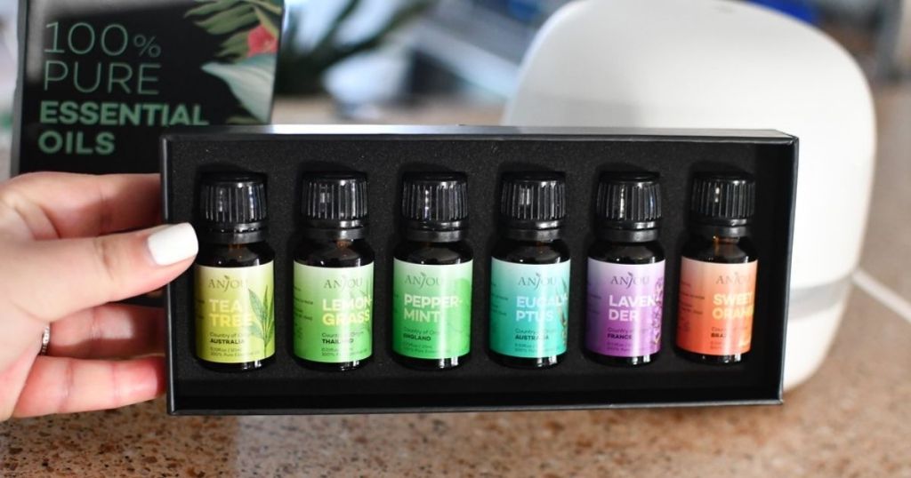 hand holding a box of essential oils