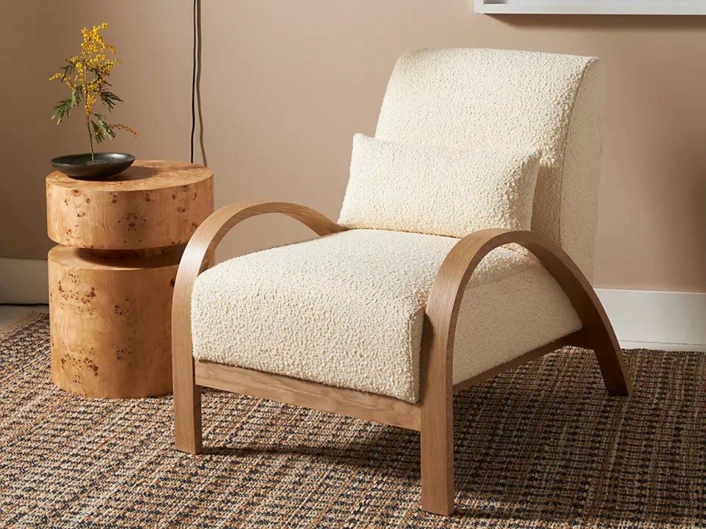 cream-colored chair with wooden arms and legs
