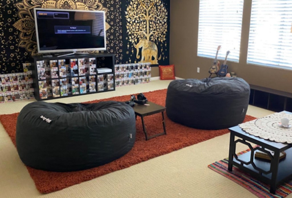 two dark gray lovesac bean bag knockoffs sitting in living room with tv media center