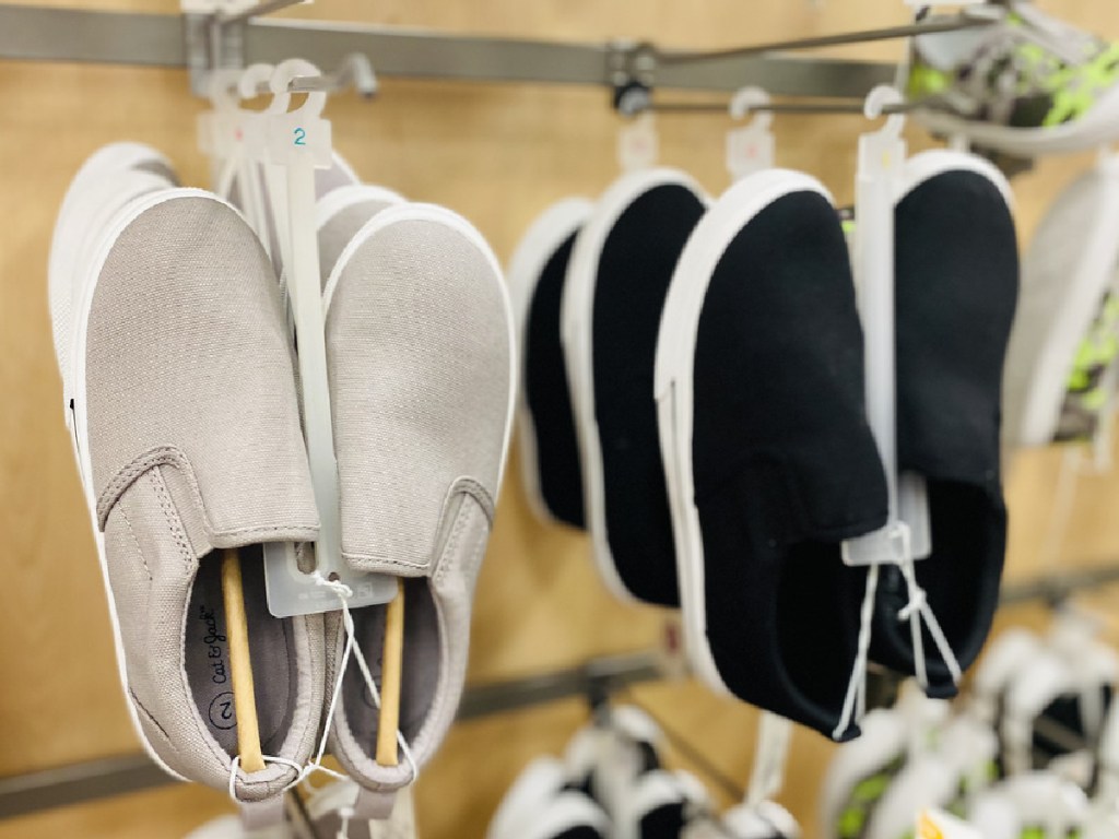 black and white pairs of slip on sneaker on store display