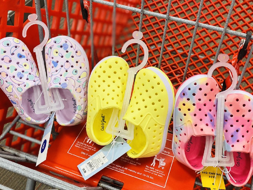 three pair of kids water shoes in red grocery cart