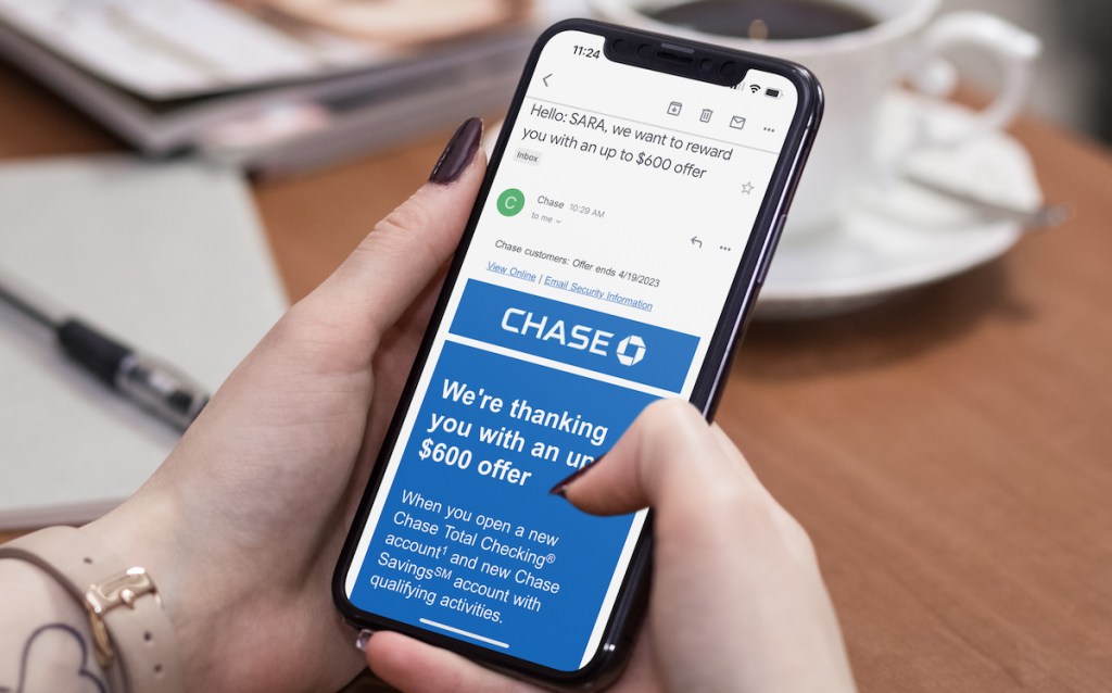hand holding phone with chase credit card 600 dollar cash offer best way to save money saving tips
