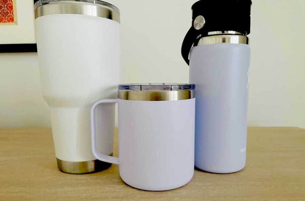 white and purple mugs on table