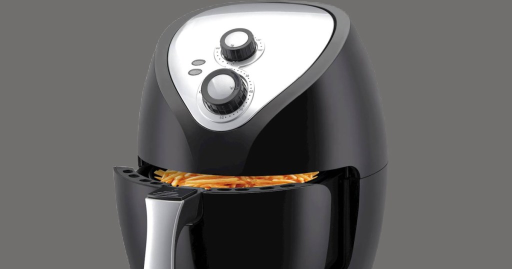 air fryer with basket partially opened containing fries