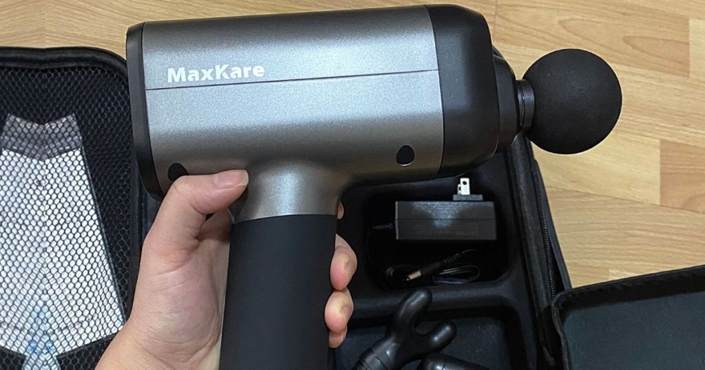 hand holding MaxKare massage gun