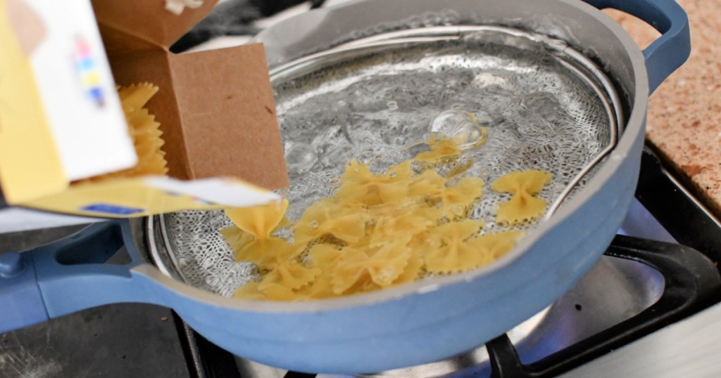 pouring pasta into boiling water