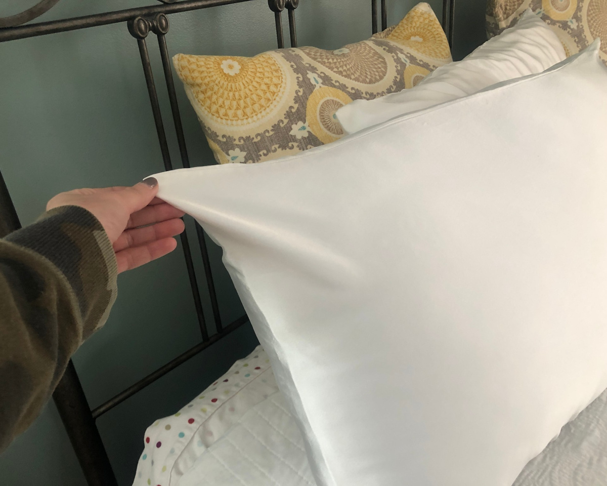 silk pillowcase in hand pulling corner