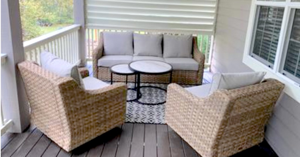 set of wicker patio furniture on deck with coffee tables