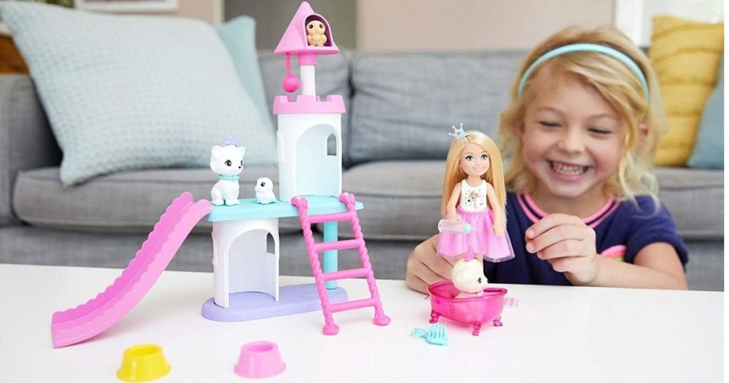girl playing with Barbie Chelsea Pet Castle