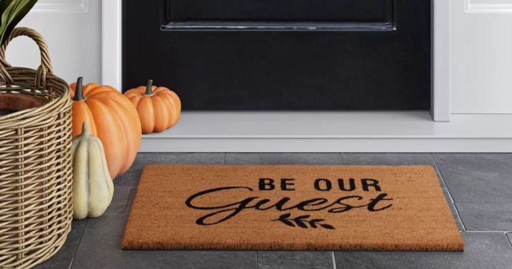 Be Our Guest Doormat on porch with black door