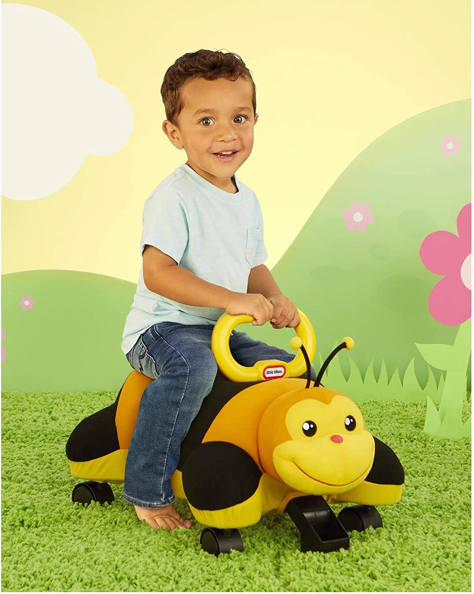 Boy riding little tikes Bee Racer
