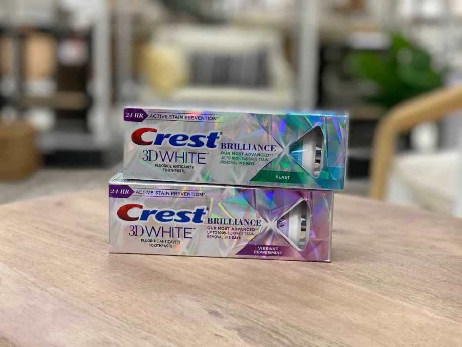 CREST 3d White Brilliance Toothpastes stacked on table