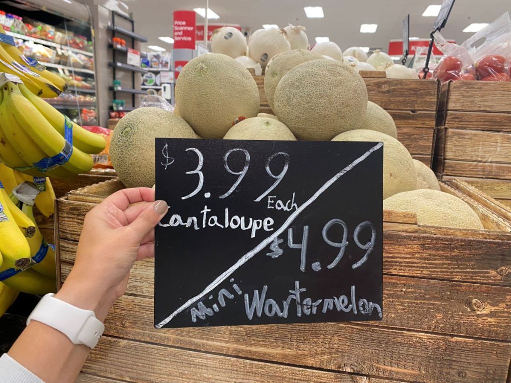 hand holding a price sign by cantaloupe at Target