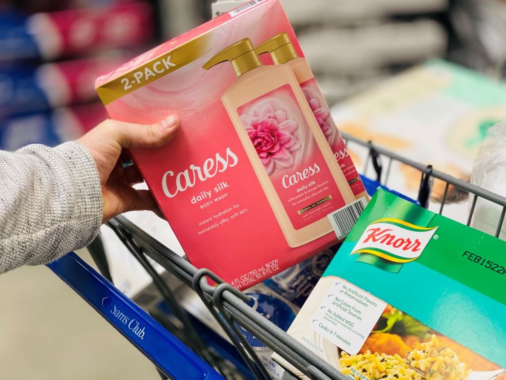 hand holding a box of Caress in a Sam's Club cart