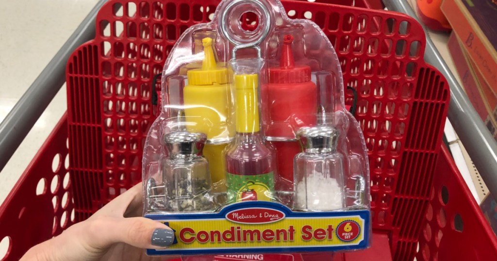 Hand holding a toy condiment set