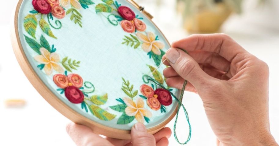 hands doing embroidery flowers