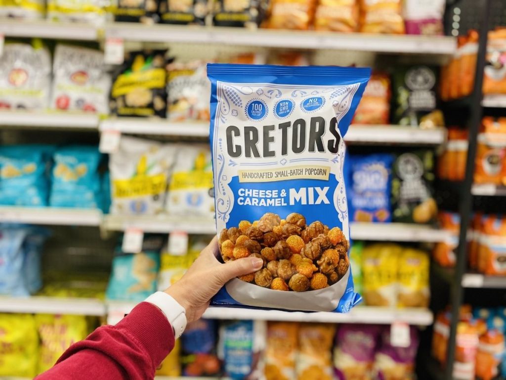 Hand holding a bag of Cretors popcorn