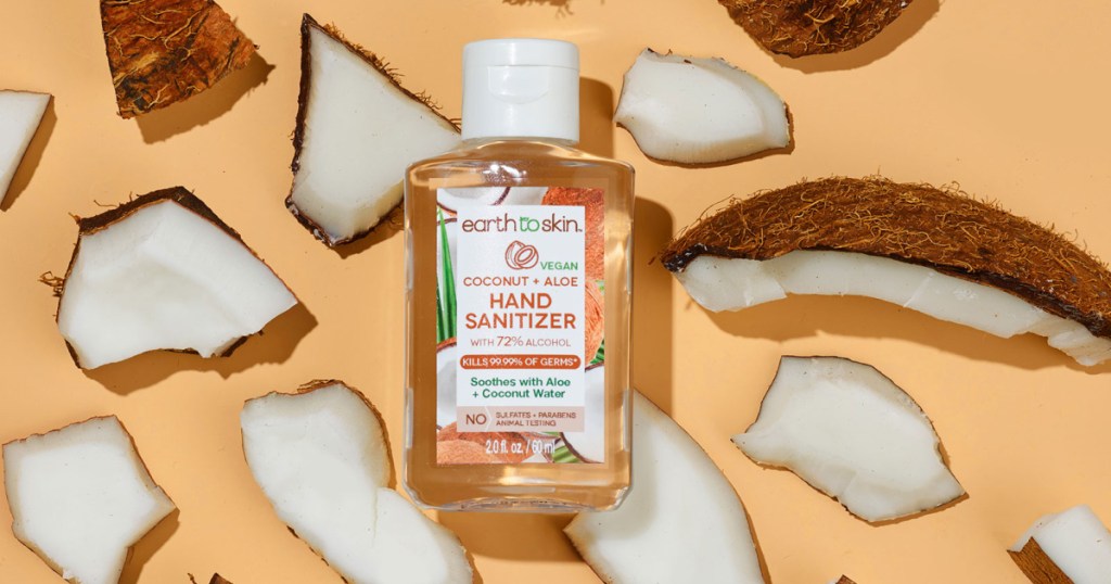 Earth to Skin brand hand sanitizer near pieces of fresh coconut