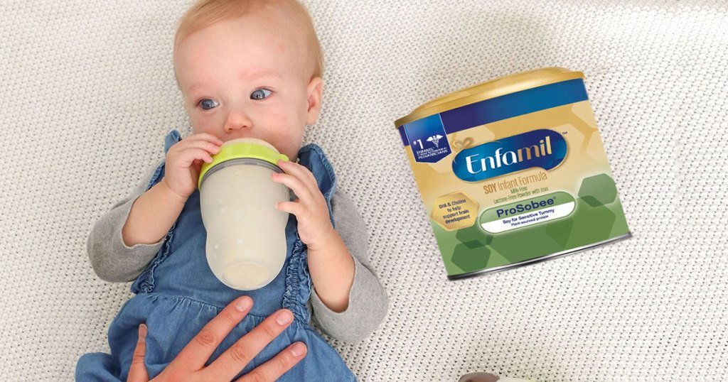 baby laying on blanket holding bottle with container of enfamil formula next to them