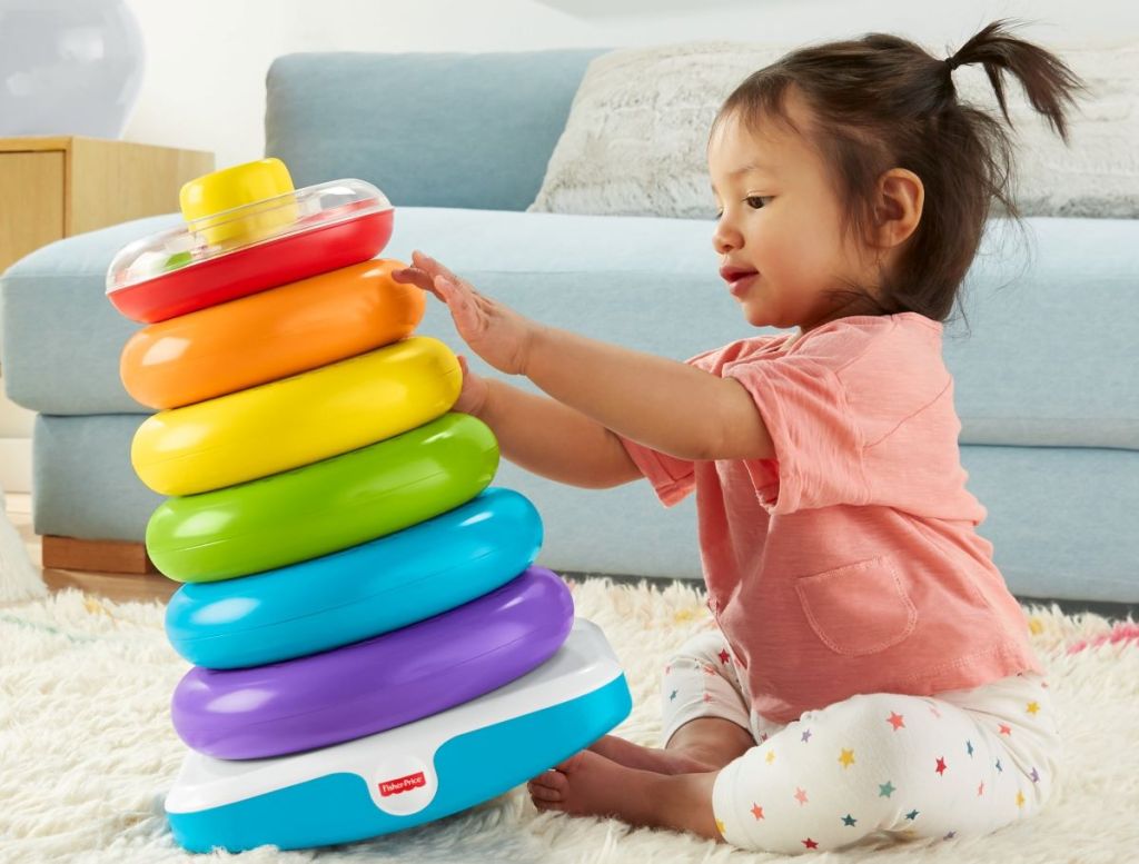 kid playing with a Fisher-Price Giant Rock-a-Stack